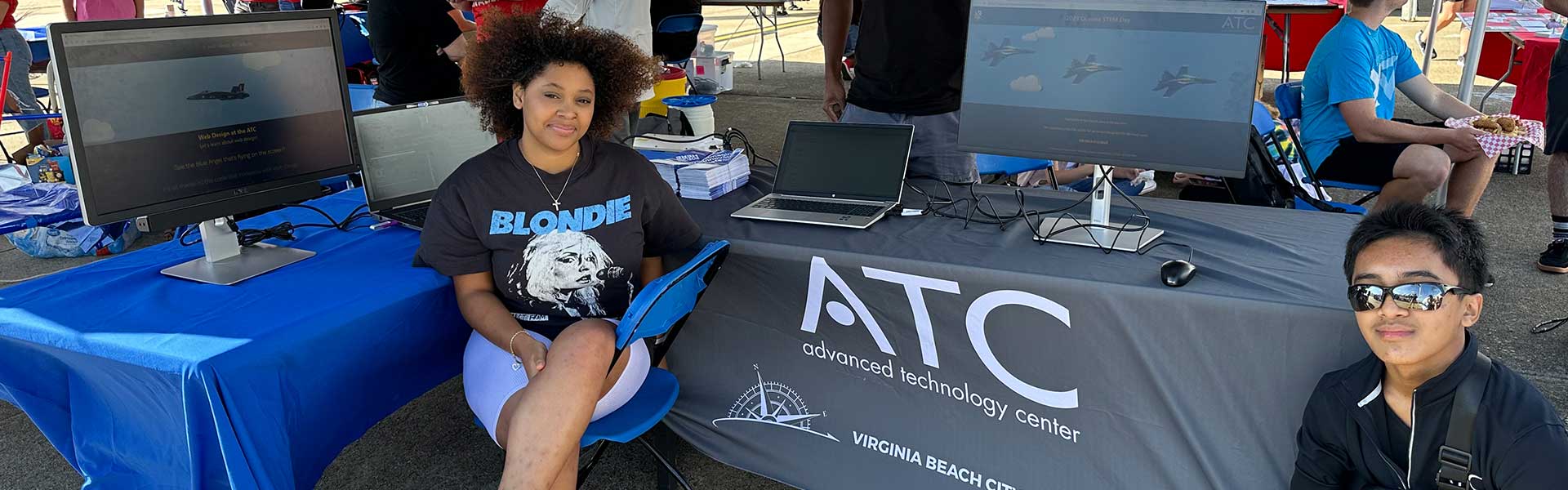 Two students showing website at Air Show.